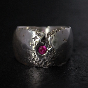Wide silver ring with faceted ruby
