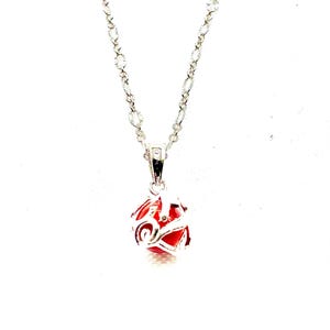 May include: A silver necklace featuring a pendant with a red sphere within a silver filigree design. The necklace chain is silver with a delicate link pattern. The background is plain white, highlighting the jewellery.
