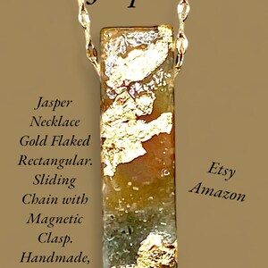 May include: A handmade Nephrite Canadian Jasper necklace with a rectangular pendant. The pendant is gold flaked and has a sliding chain with a magnetic clasp. The image includes the text "Etsy" and "Amazon".