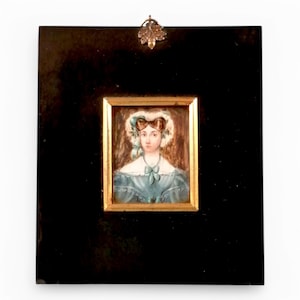 Georgian portrait miniature of a young woman in blue dress, 18th to early 19th century, antique ebonised frame with brass trim