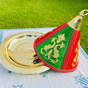 May include: A gold metal serving tray with an ornate design and a green and red fabric cover with gold embroidery.