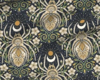 May include: A dark blue fabric with a repeating pattern of stylized spiders, moons, suns, and flowers. The spiders are white with gold accents and the flowers are white with yellow centers.