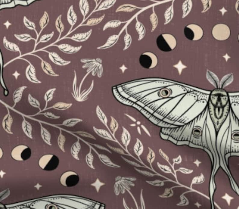 May include: A seamless pattern featuring a white moth with a brown head, surrounded by beige and white leaves and branches on a dark purple background. The pattern also includes white stars and crescent moons.