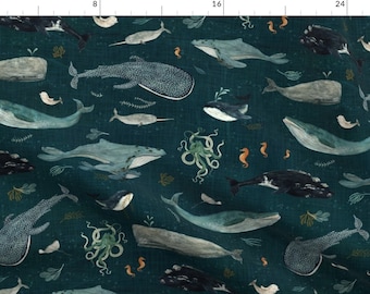 May include: A teal blue fabric with a repeating pattern of whales, narwhals, seahorses, and an octopus. The whales are in various shades of blue and gray, and the seahorses are orange.