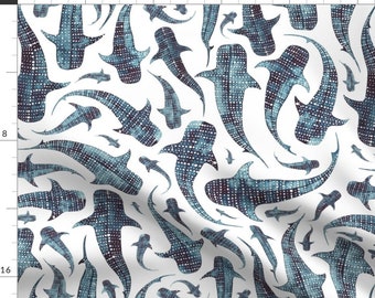 May include: A white fabric with a repeating pattern of blue whale sharks. The whale sharks are stylized and have a dotted pattern.