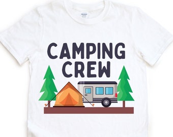 May include: White t-shirt with the text "Camping Crew" in navy blue letters. The shirt features a cartoon illustration of a camper van, a tent, and two pine trees.