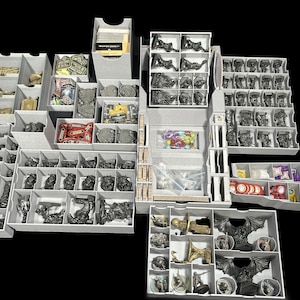 May include: A set of grey plastic storage boxes with compartments for organising game pieces. The boxes are filled with various miniature figures, dice, and other game components.