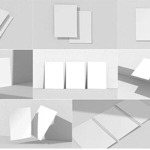 May include: A set of blank white cards in various arrangements, including stacked, fanned, and leaning against a wall. The cards are all the same size and shape, and they are perfect for showcasing your designs or messages.