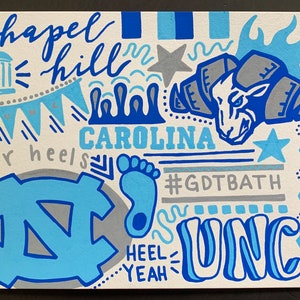 May include: A hand-painted illustration of the University of North Carolina Tar Heels mascot, a ram, with the words "Chapel Hill", "Carolina", "Tar Heels", "UNC", and "#GDTBATH". The illustration is in shades of blue, gray, and white.