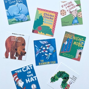 May include: A collection of ten miniature children's books, including "The Very Hungry Caterpillar", "Goodnight Moon", "The Cat in the Hat", "Brown Bear, Brown Bear, What Do You See?", "If Animals Kissed Good Night", "Chicka Chicka Boom Boom", "The Rainbow Fish", and "If You Give a Mouse a Cookie".