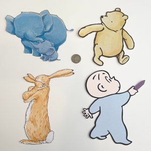 May include: A set of four paper cutouts featuring characters from children's books. The cutouts include a blue elephant with a baby elephant, a brown rabbit with a baby rabbit, a yellow bear, and a blue baby holding a purple crayon.