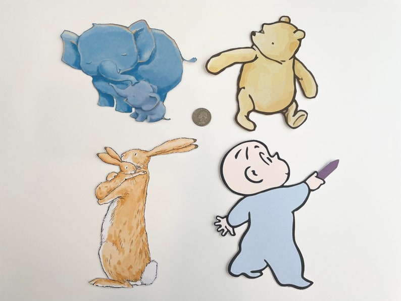May include: A set of four paper cutouts featuring characters from children's books. The cutouts include a blue elephant with a baby elephant, a brown rabbit with a baby rabbit, a yellow bear, and a blue baby holding a purple crayon.