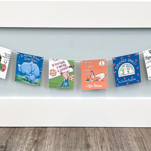 May include: A banner of children's book covers, including "Goodnight Moon", "The Very Hungry Caterpillar", "If You Give a Mouse a Cookie", "Green Eggs and Ham", "Barnyard Dance", "Where's Spot?", and "Corduroy".