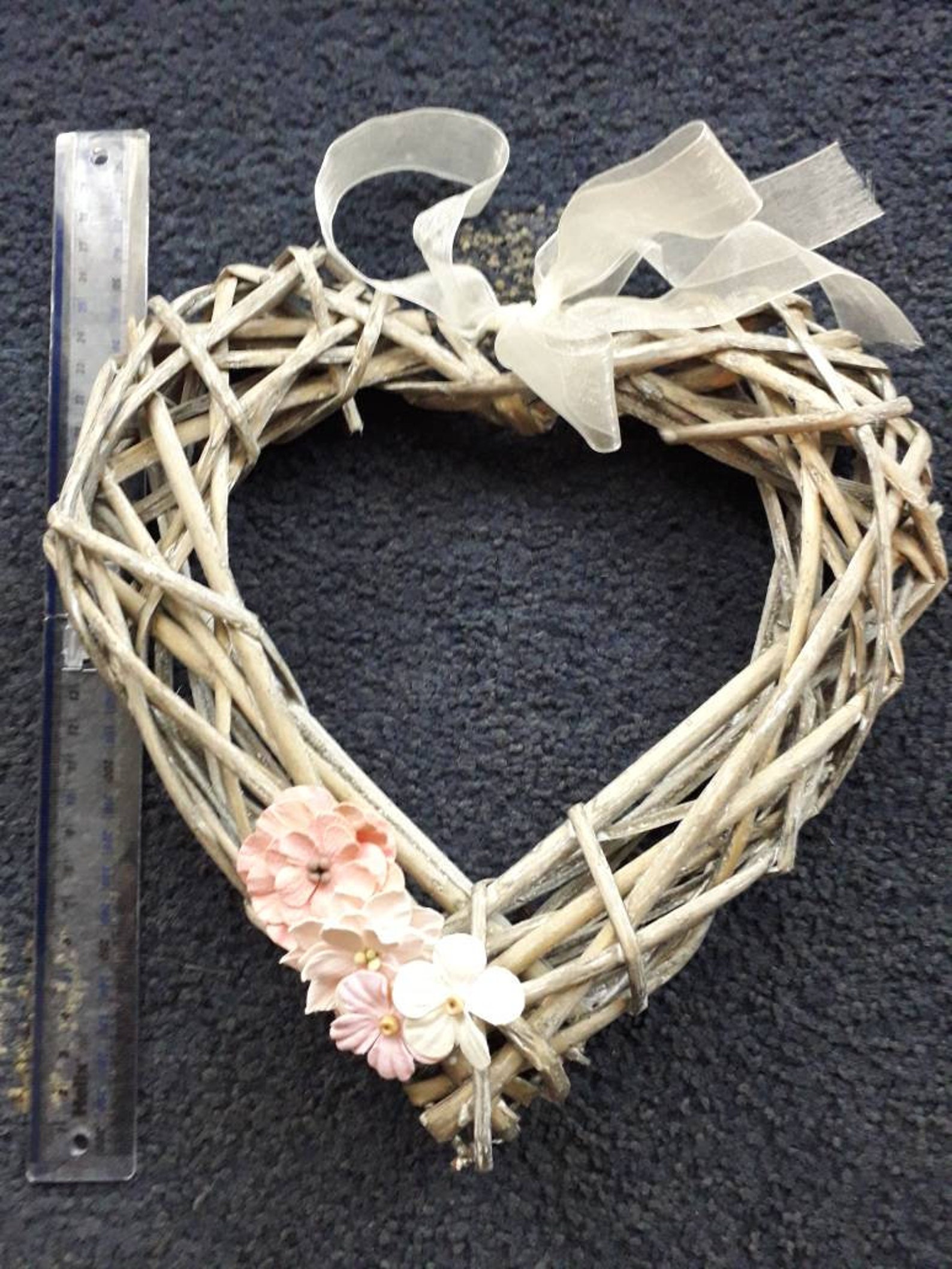 Wicker heart shaped wreath with paper flower embellishments in Etsy