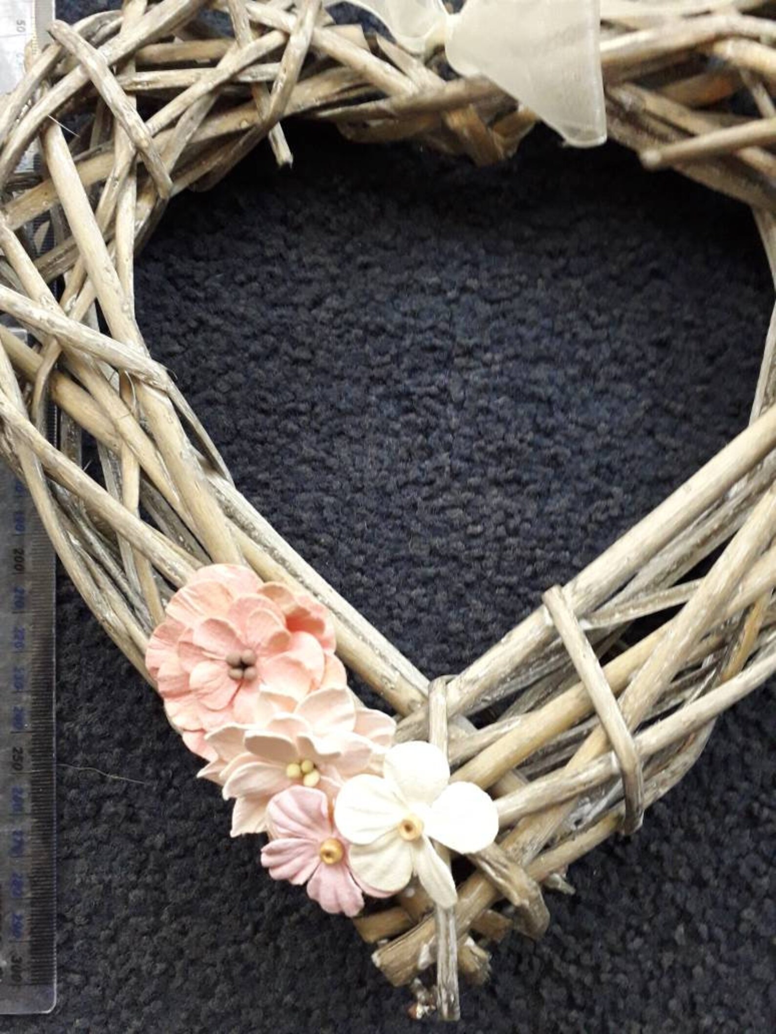 Wicker heart shaped wreath with paper flower embellishments in Etsy