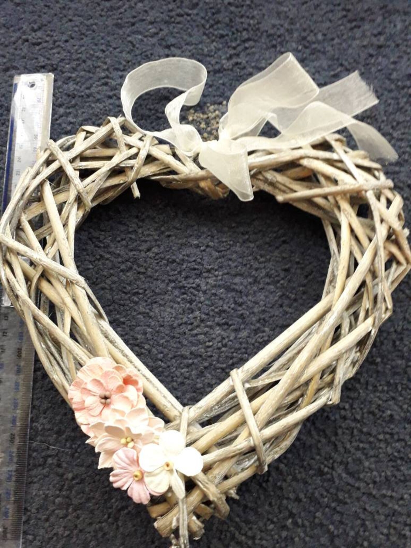 Wicker heart shaped wreath with paper flower embellishments in Etsy