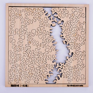 Peut inclure: Un puzzle en bois avec un design organique unique. Les pièces du puzzle sont brun clair avec des contours brun foncé, et le puzzle est partiellement assemblé. Le texte "High difficulty puzzle series" est visible.