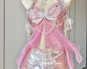 May include: A pink and white mermaid costume with a pearl-embellished top, a sheer pink skirt, and a pearl necklace. The costume is on a mannequin.