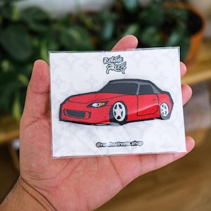 May include: Red embroidered patch of a Honda S2000 sports car with the text "Run the Streets" above the car and "@runthestreets.shop" below the car.