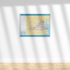 May include: A framed map of Virginia, featuring a detailed depiction of the state's geography, cities, and roads. The map has a blue border and includes a legend with symbols. The color palette includes shades of tan, blue, and red.