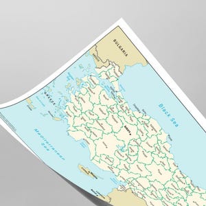 May include: A detailed map of the Black Sea region, including parts of Turkey, Greece, Bulgaria, and Russia. The map features country borders, cities, and bodies of water, with a light blue sea and beige landmasses. The map is slightly curled.