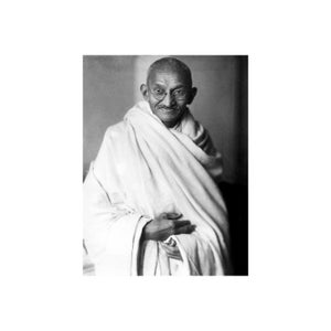 May include: A black and white portrait of Mahatma Gandhi wearing round glasses and a white shawl.