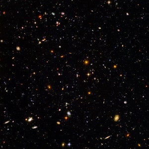 May include: A black and white image of a vast expanse of space filled with countless stars and galaxies. The image is a deep field view of the universe, showcasing the vastness and beauty of the cosmos.