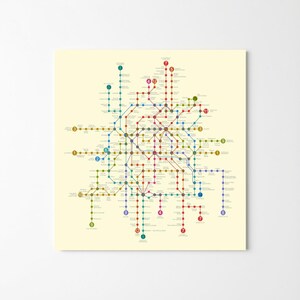 May include: A detailed subway map print with a cream backdrop. The map displays a network of colored lines, including red, blue, green, and yellow, with numbered stations and connecting routes. The design is a comprehensive representation of a city's public transport system.
