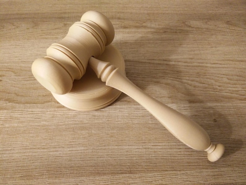 May include: A wooden gavel with a round base, the gavel is light brown in color.