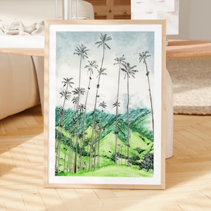 Pode incluir: Uma impress&atilde;o em aquarela emoldurada com uma paisagem de palmeiras altas em um fundo de colinas verdes e um c&eacute;u azul claro. A obra de arte est&aacute; em uma moldura de madeira natural, adequada para decora&ccedil;&atilde;o de parede.