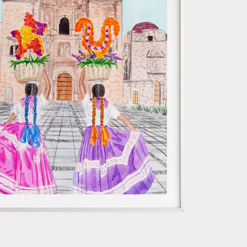 May include: Two people in colourful dresses and long braids walk away from the camera, carrying baskets of flowers in front of a large building.