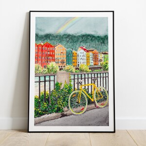 May include: A watercolour painting of a yellow bicycle parked in front of a row of colourful buildings. A rainbow is visible in the sky above the buildings.