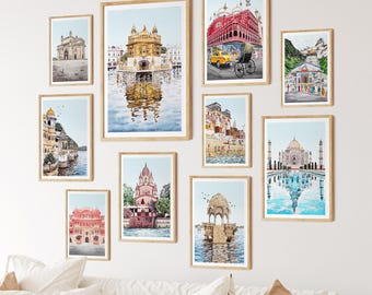 May include: A set of framed watercolour prints depicting famous Indian landmarks. The artwork shows detailed representations of temples, palaces, and historical sites, with vibrant colours and reflections in water. The frames are a natural wood tone.