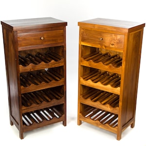 May include: Two wooden wine racks with a single drawer at the top. The wine racks have four shelves each and are made of dark brown wood.