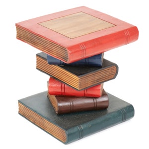May include: A stack of five books with wooden covers. The top book is red with a wooden inlay and the rest are various shades of blue, black, red, and brown.