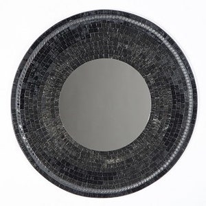 May include: A round black mosaic mirror with a bevelled edge. The mirror has a circular reflection in the centre.