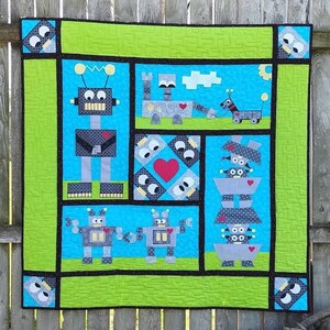 May include: A green, blue, black, and gray patchwork quilt with a robot theme. The quilt features various robots with different designs and poses. The quilt is made with a variety of fabrics, including polka dots, stripes, and solids.