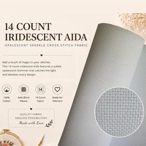 May include: 14 count iridescent Aida fabric for cross stitch, featuring a light grey, opalescent weave. The text reads 14 COUNT IRIDESCENT AIDA, OPALESCENT SPARKLE CROSS STITCH FABRIC, 100% Cotton, Aida Block Weave, 14 Count Fabric, and QUALITY FABRIC.