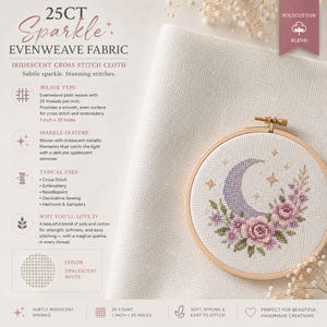 May include: A 25-count opalescent white evenweave fabric with iridescent metallic filaments. The polycotton blend cloth is displayed with a wooden embroidery hoop containing a cross-stitched crescent moon and floral design on the fabric.