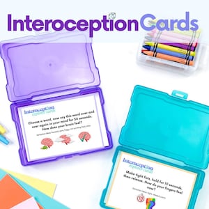 May include: Two open plastic boxes containing Interoception Explorer Cards. One box is purple, the other is teal. The cards have text and illustrations about body awareness. A small clear box of crayons is also visible.
