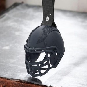 Puede incluir: Llavero de casco de fútbol negro con una correa de cuero negro y un llavero plateado. STL FILE y DIGITAL FILE están escritos en el fondo.