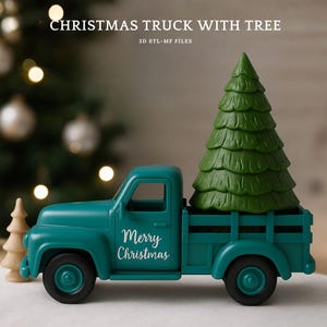 May include: A teal-colored toy truck with a green Christmas tree in the bed. The truck has black wheels and the words "Merry Christmas" on the door. The background includes a blurred Christmas tree with lights.