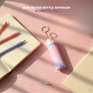 May include: A pink and purple mini water bottle keychain with a gold ring. The keychain is next to a notebook and pens. The text "MINI WATER BOTTLE KEYCHAIN" and "3D PRINT STL FILE" is visible.