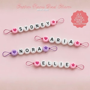 May include: Custom name bead charms spelling out "SYDNEY", "ARIA", "NORA", and "ELLIE". Each charm features white letter beads, heart or star end beads, and a loop. The background is a soft pink.
