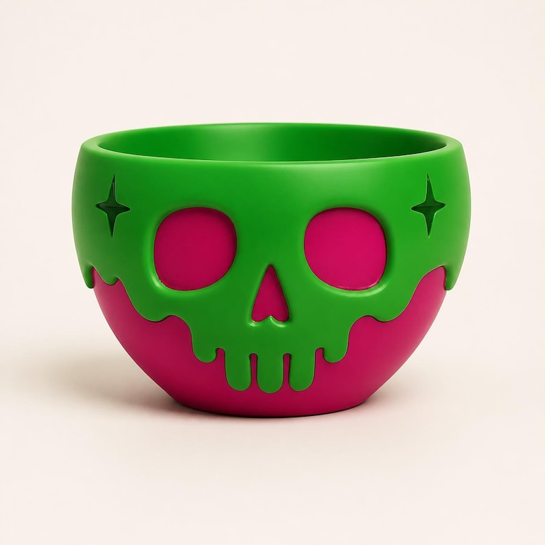 May include: A round bowl featuring a bright green skull overlay with a dripping effect over a solid magenta base. The green skull design includes two star-shaped cutouts on the sides and hollowed-out eye sockets that reveal the magenta color underneath.