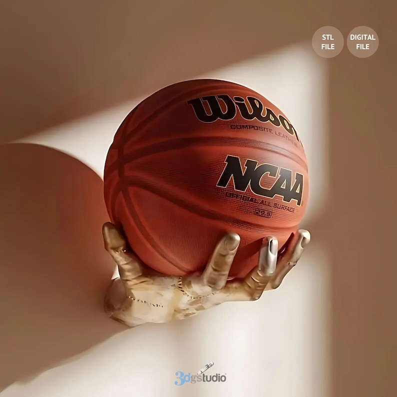 May include: A golden hand sculpture holding a brown and orange basketball with the text "Wilson Composite Leather NCAA Official All Surface 29.5" printed on it.