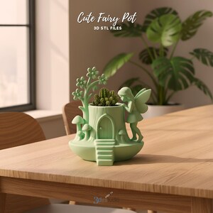 May include: A light green fairy pot with a tree trunk design, a fairy figurine, and a small door. The pot holds a small cactus. The text "Cute Fairy Pot" and "3D STL FILES" are visible.