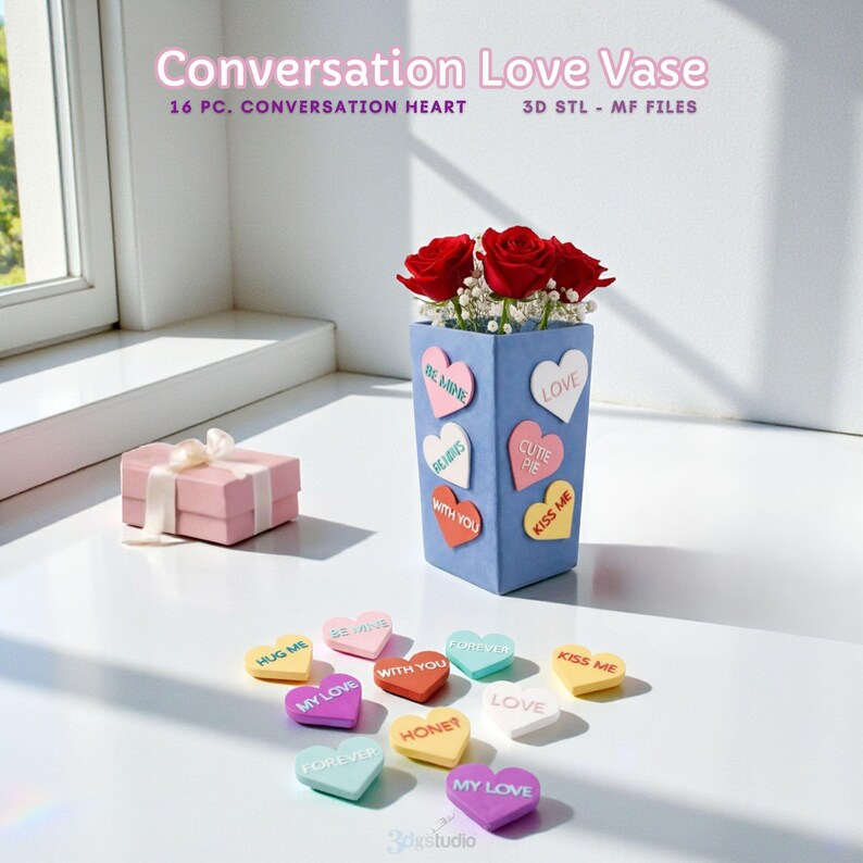 May include: A blue vase with heart-shaped conversation candies and red roses. The vase has heart-shaped stickers with phrases like "Be Mine" and "Love." A pink gift box with a white ribbon is on the left. The text "Conversation Love Vase" is at the top.