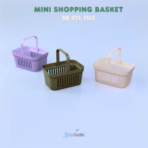 May include: Three mini shopping baskets in lavender, olive green, and beige. Each basket has a handle and vertical slots. The text "MINI SHOPPING BASKET" and "3D STL FILE" are at the top.