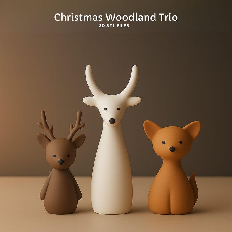 May include: A trio of woodland animal figurines. The set includes a brown deer with antlers, a tall white deer, and a tan fox. The text "Christmas Woodland Trio" and "3D STL FILES" are at the top.